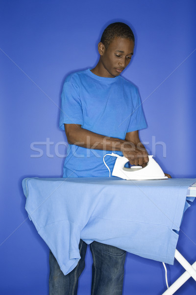 Teenage boy doing chores. Stock photo © iofoto