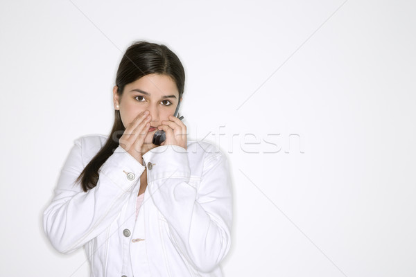 Girl whispering  into cellphone. Stock photo © iofoto