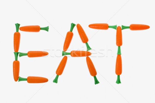 Eten wortelen woord uit witte kleur Stockfoto © iofoto