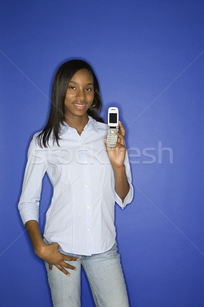 Teenage girl holding cellphone. Stock photo © iofoto