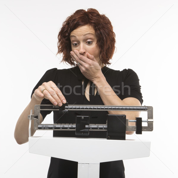 Stock photo: Woman weighing self.