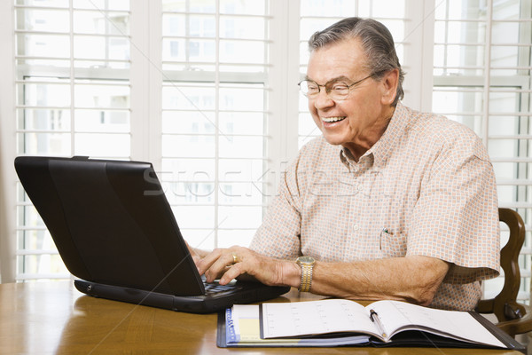 Mature man with laptop. Stock photo © iofoto