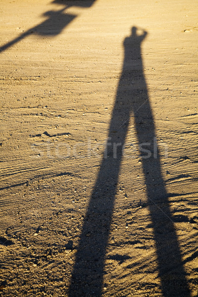 Lung umbră om murdărie apus de soare masculin Imagine de stoc © iofoto
