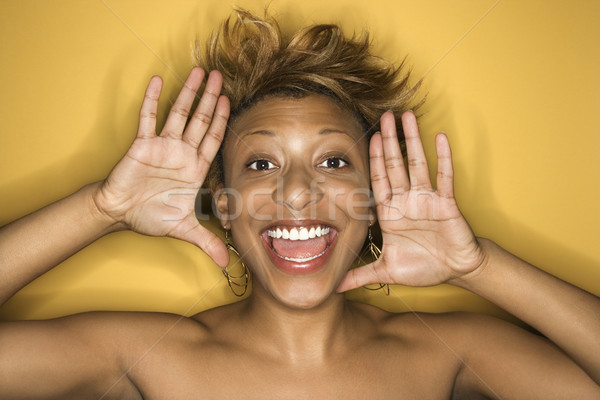 Woman framing smiling face. Stock photo © iofoto
