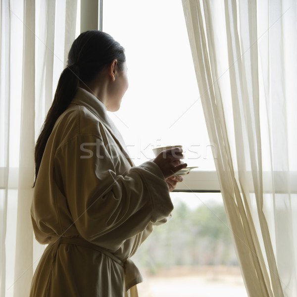 Woman looking out window. Stock photo © iofoto