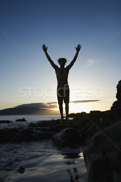 Adult male jumping on beach. Stock photo © iofoto