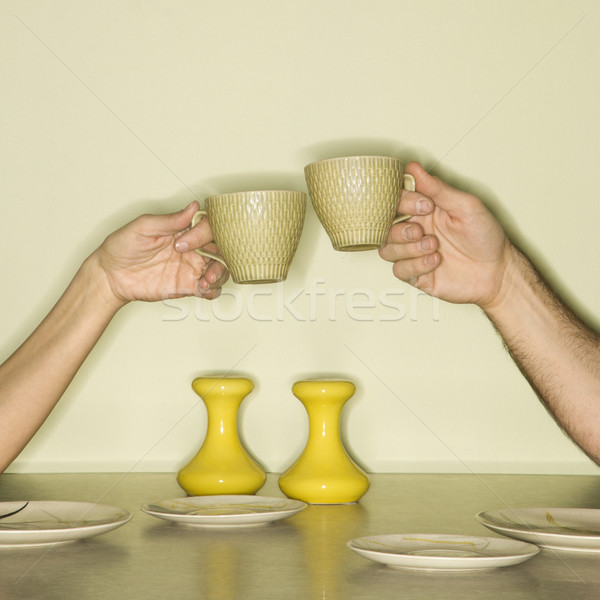 Stock photo: Hands toasting cups.