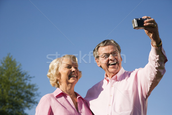 Mature couple taking picture. Stock photo © iofoto