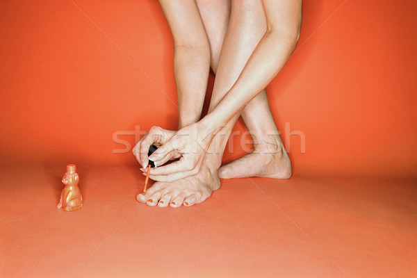 Mujer pintura piernas pies caucásico naranja Foto stock © iofoto