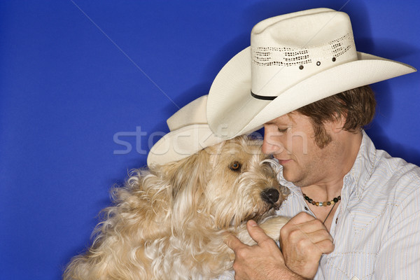 Dog and man in cowboy hats. Stock photo © iofoto