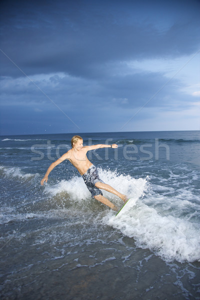 Boy riding skimboard. Stock photo © iofoto