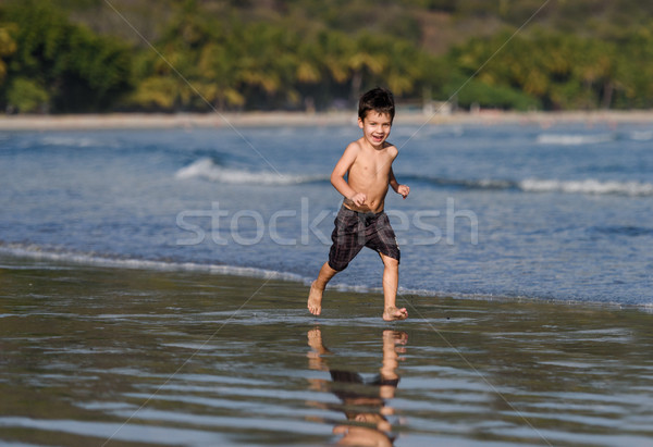 Happy boy is running on coastline Stock photo © Ionia