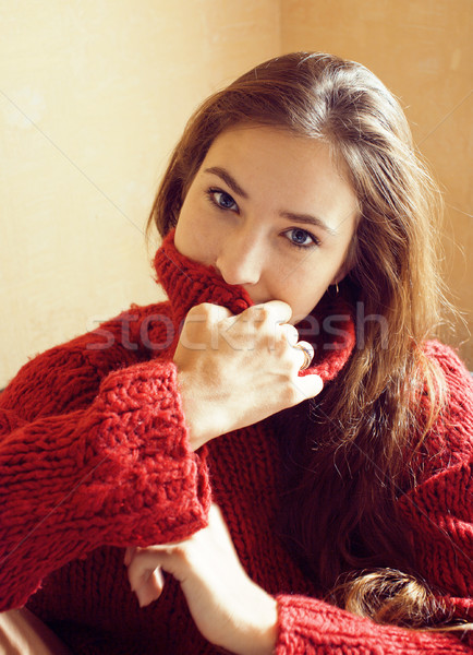 young pretty real woman in red sweater and scarf all over her fa Stock photo © iordani