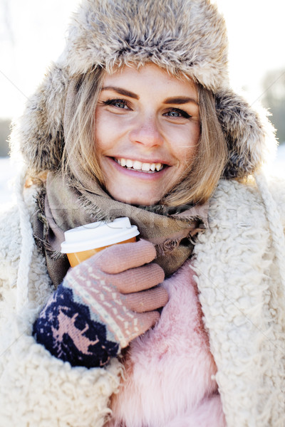 young pretty teenage hipster girl outdoor in winter snow park having fun drinking coffee, warming up Stock photo © iordani