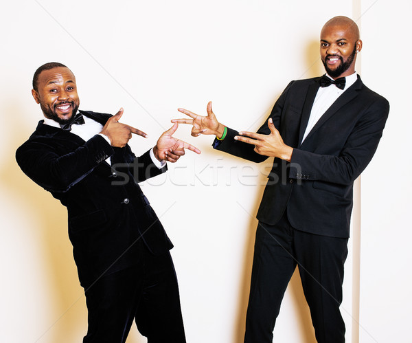 two afro-american businessmen in black suits emotional posing, g Stock photo © iordani