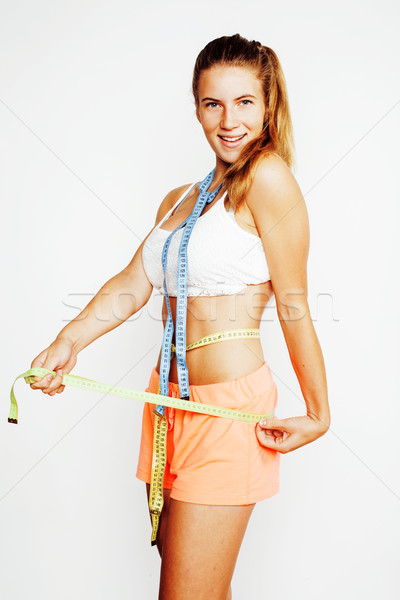 woman measuring waist with tape on knot like a gift, tan isolated close up white background Stock photo © iordani