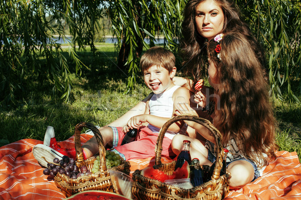 cute happy family on picnic laying on green grass mother and kid Stock photo © iordani