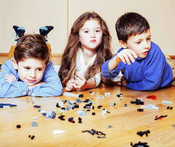 funny cute children playing lego at home, boys and girl smiling, first education role lifestyle Stock photo © iordani