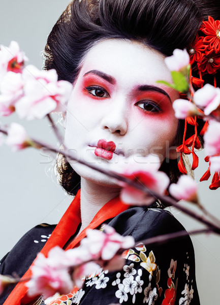 young pretty geisha in black kimono among sakura, asian ethno close up Stock photo © iordani