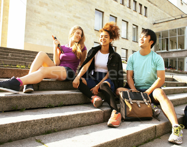 cute group of teenages at the building of university with books  Stock photo © iordani