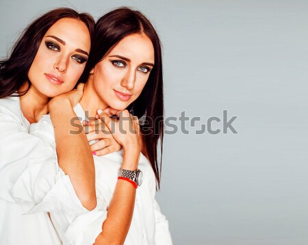 tree pretty stylish young woman with same hairstyle and makeup, best friend together having fun, lif Stock photo © iordani