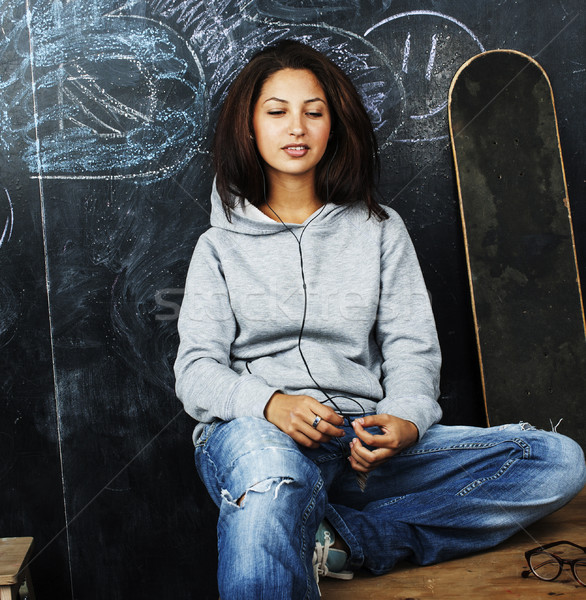 young cute teenage girl in classroom at blackboard seating on ta Stock photo © iordani