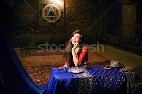 young pretty asian girl in bright colored interior on carpet view Stock photo © iordani