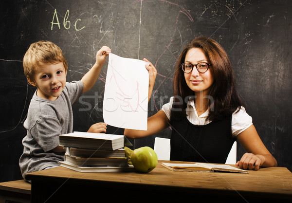 little cute boy with young teacher in classroom studying at blac Stock photo © iordani