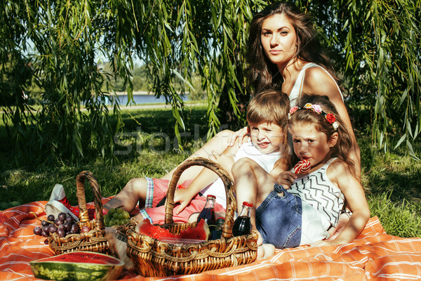cute happy family on picnic laying on green grass mother and kid Stock photo © iordani