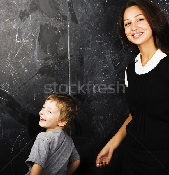 little cute boy with young teacher in classroom studying at blac Stock photo © iordani
