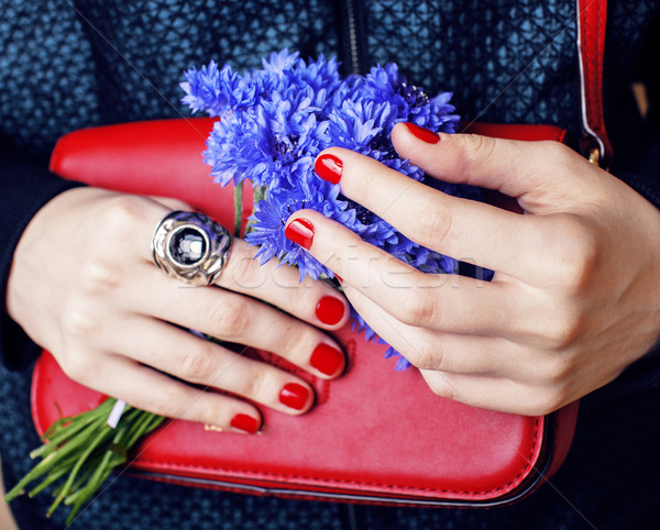 close up portrait of girls manicured hands holding small cute red handbag and cornflower bouquet, li Stock photo © iordani