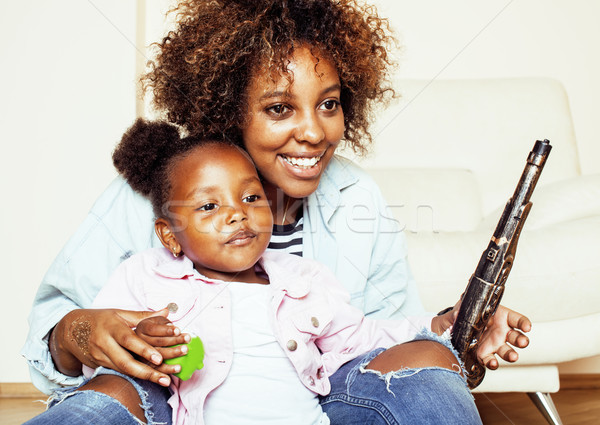 adorable sweet young afro-american mother with cute little daughter, hanging at home, having fun pla Stock photo © iordani