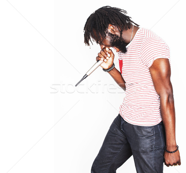 Stock photo: young handsome african american boy singing emotional with micro