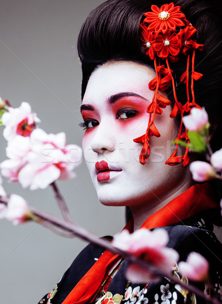 young pretty geisha in black kimono among sakura, asian ethno close up Stock photo © iordani
