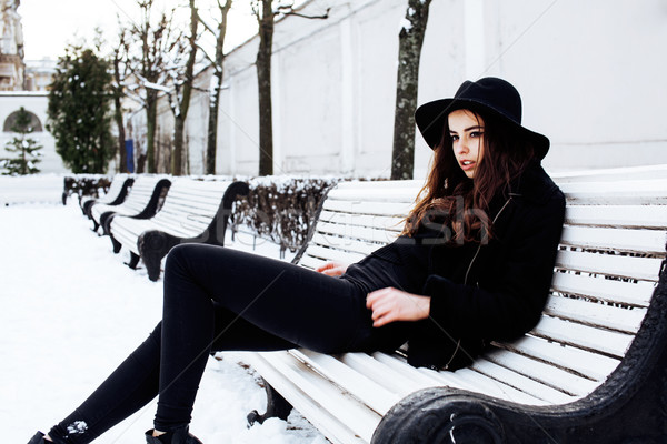 young pretty modern hipster girl waiting on bench at winter snow park alone, lifestyle people concep Stock photo © iordani