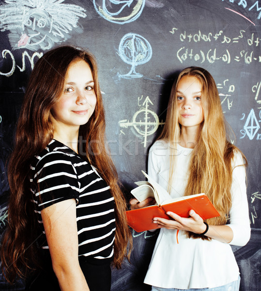 back to school after summer vacations, two teen real girls in classroom with blackboard painted toge Stock photo © iordani