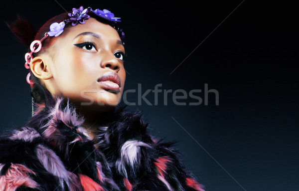 young pretty african american woman in spotted fur coat and flowers jewelry on head smiling sweet et Stock photo © iordani