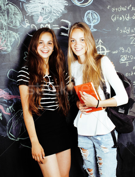 back to school after summer vacations, two teen real girls in classroom with blackboard painted toge Stock photo © iordani