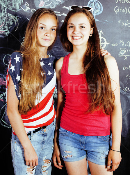 back to school after summer vacations, two teen real girls in classroom with blackboard painted toge Stock photo © iordani