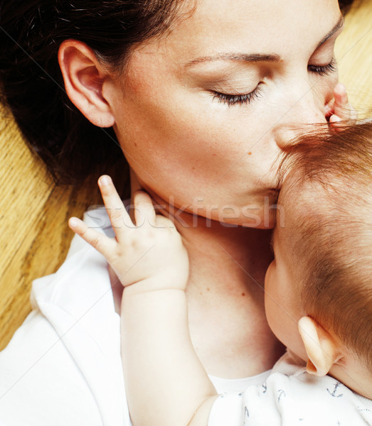 Stock photo: young brunette happy mother holding toddler baby son, breast-fee