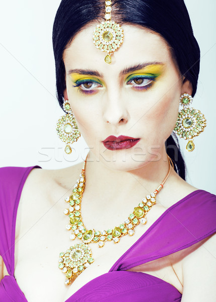 young pretty caucasian woman like indian in ethnic jewelry close up on white, bridal bright makeup f Stock photo © iordani