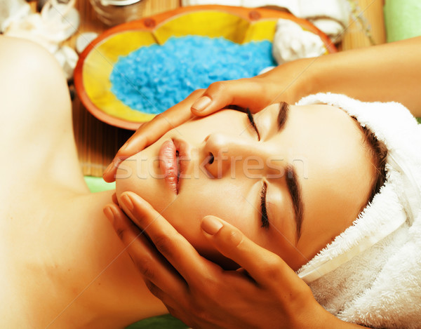 stock photo attractive lady getting spa treatment in salon, close up asian hands on face Stock photo © iordani