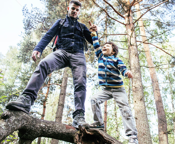little son with father climbing on tree together in forest, lifestyle people concept, happy smiling  Stock photo © iordani