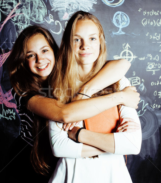 back to school after summer vacations, two teen real girls in classroom with blackboard painted toge Stock photo © iordani