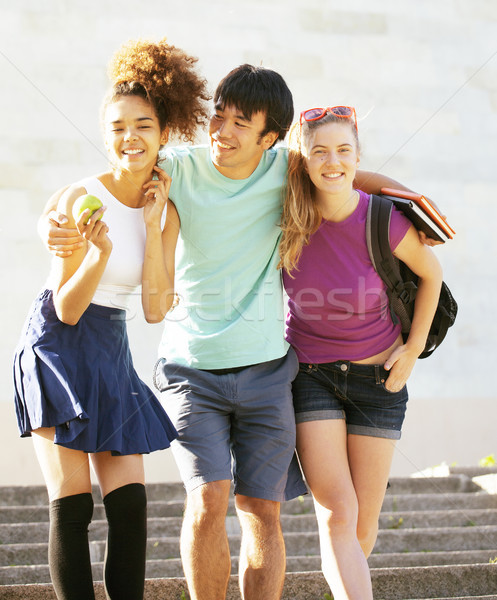 Stock photo: cute group of teenages at the building of university with books huggings, back to school