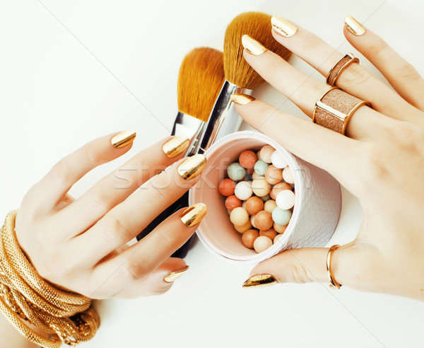 woman hands with golden manicure and many rings holding brushes, makeup artist stuff stylish, pure c Stock photo © iordani