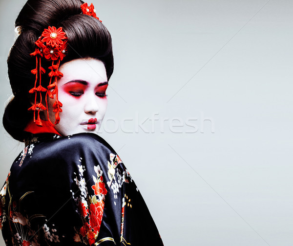young pretty geisha in kimono with sakura and red decoration des Stock photo © iordani