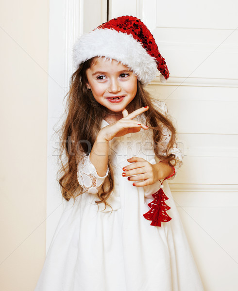 little cute girl in santas red hat waiting for Christmas gifts.  Stock photo © iordani