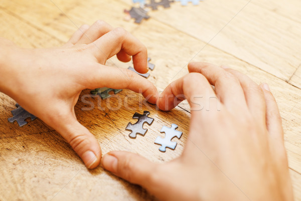 little kid playing with puzzles on wooden floor together with parent, lifestyle people concept, lovi Stock photo © iordani