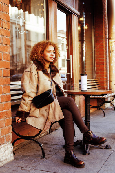 Stock photo: young pretty african american women drinking coffee outside in c